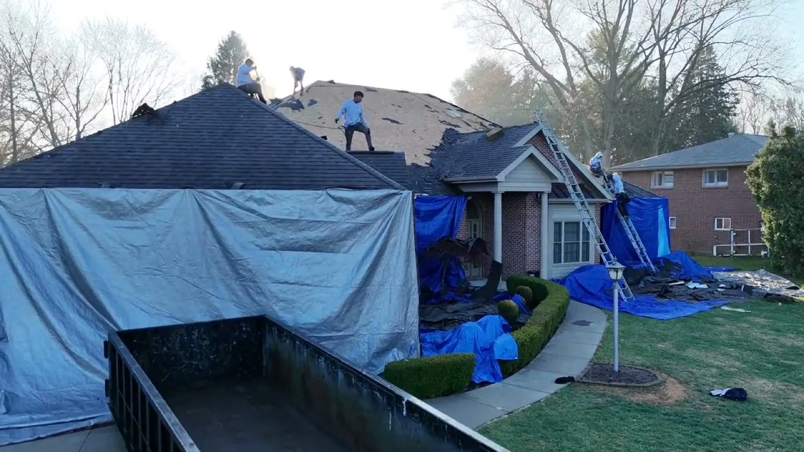 Aerial view of a C. Kalcevic crew tearing off and replacing a roof in Western Pennsylvania