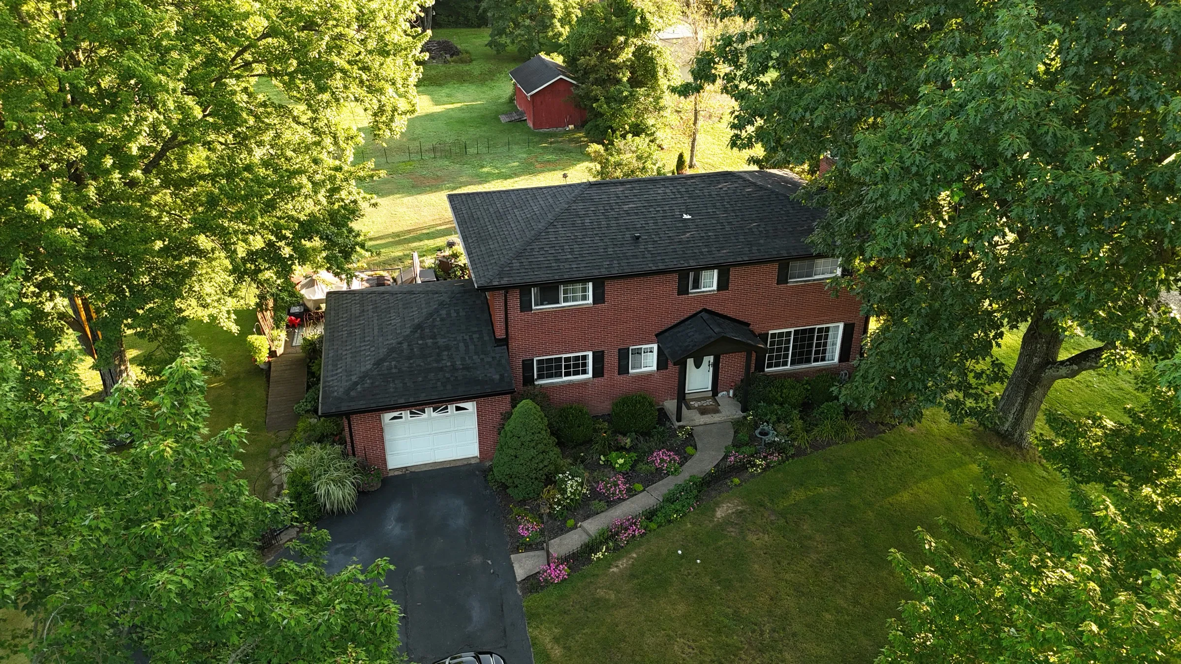 Brick colonial after C. Kalcevic Roofing completed the work
