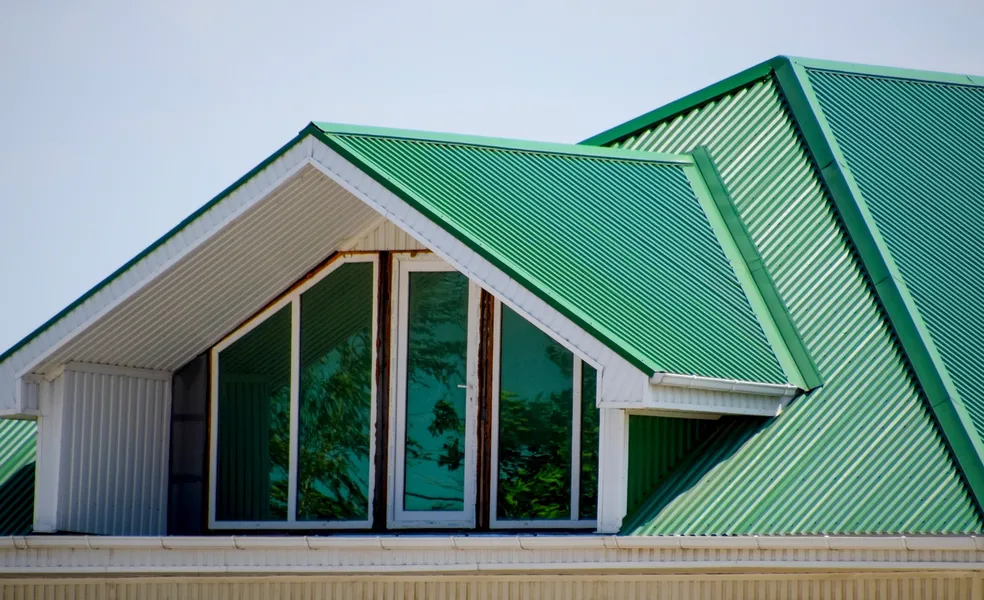 Green metal roofs on modern architectural building